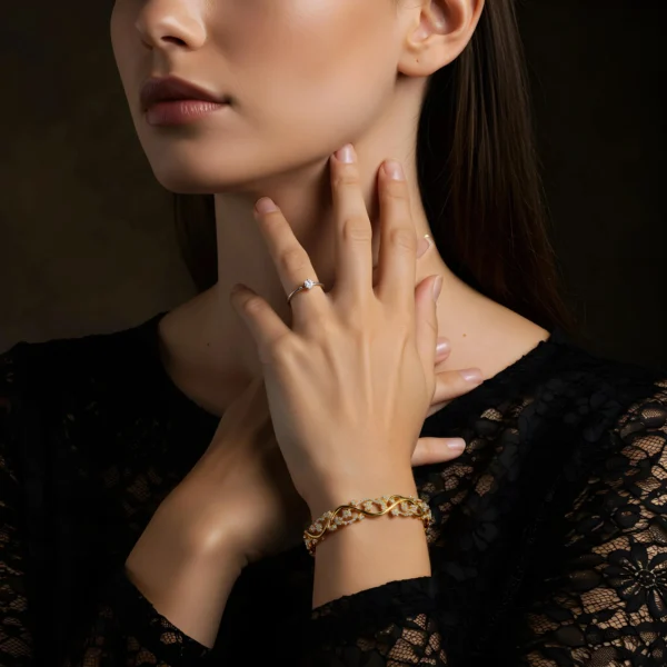 A woman wearing the Elora Vine 18k gold diamond bracelet in an Art Nouveau style, paired with a black lace dress.