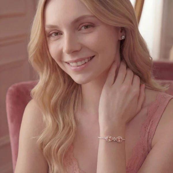A smiling woman wearing the Embress peach-pink morganite bracelet, styled as a luxury jewelry gift.