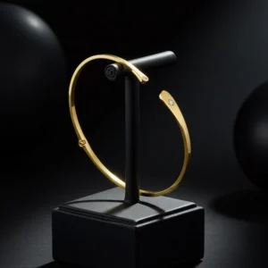 Yellow gold open cuff bracelet with diamond accents on display.