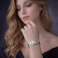 A lifestyle shot of a woman with blonde hair wearing a square diamond-faced watch, highlighting the sparkle of the jewelry.