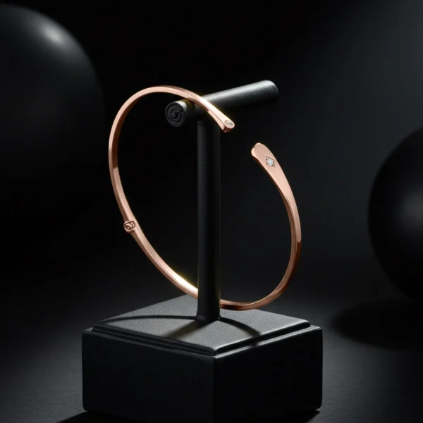 Rose gold open cuff bracelet with diamond accents on display.