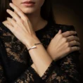 Model wearing a silver diamond open cuff bracelet.