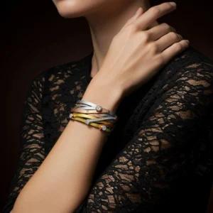 Close up of a woman wearing a tri-tone gold and diamond Trinity Luxe bracelet