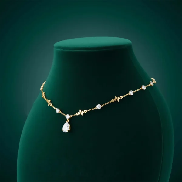 Gold Cleopatra necklace on green bust display