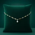 Cleopatra gold necklace on green velvet pillow