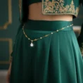 Gold Cleopatra waist chain on green dress