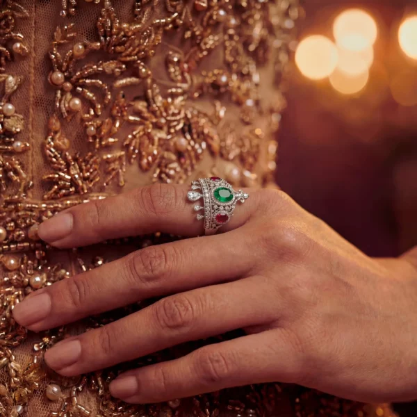 Detailed view of crown ring paired with gold sequin dress.