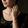 Woman wearing Ecliptia ring and diamond bracelet