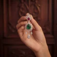 Person holding a single Empress earring to show intricate diamond detail.