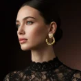 Side profile of a woman wearing chunky twisted gold hoop earrings with a black lace top.