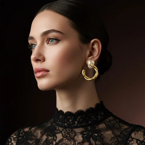 gilded-elegance-twisted-hoops-lifestyle Side profile of a woman wearing chunky twisted gold hoop earrings with a black lace top.