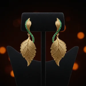 Pair of gold Emerald Whisper leaf earrings on a black jewelry stand.