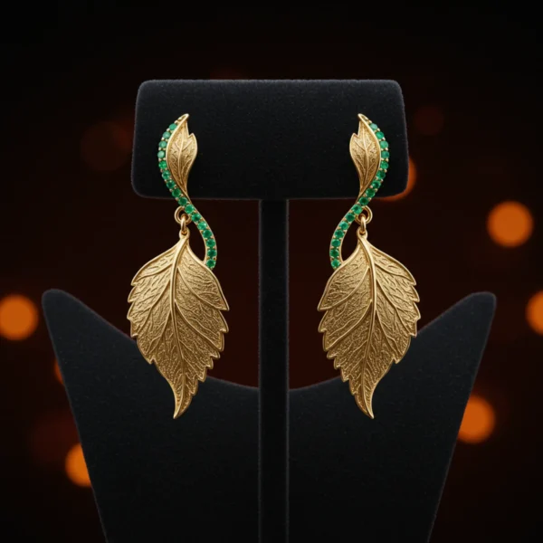 Pair of gold Emerald Whisper leaf earrings on a black jewelry stand.