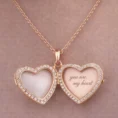 Open rose gold heart locket with "you are my heart" engraved inside.