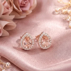 Pair of Lullaby Stud earrings on pink silk