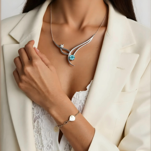 luminous-harmony-lifestyle Close-up of Luminous Harmony necklace and matching silver heart bracelet.