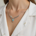 Luminous Harmony silver necklace with a blue topaz gemstone on a model.
