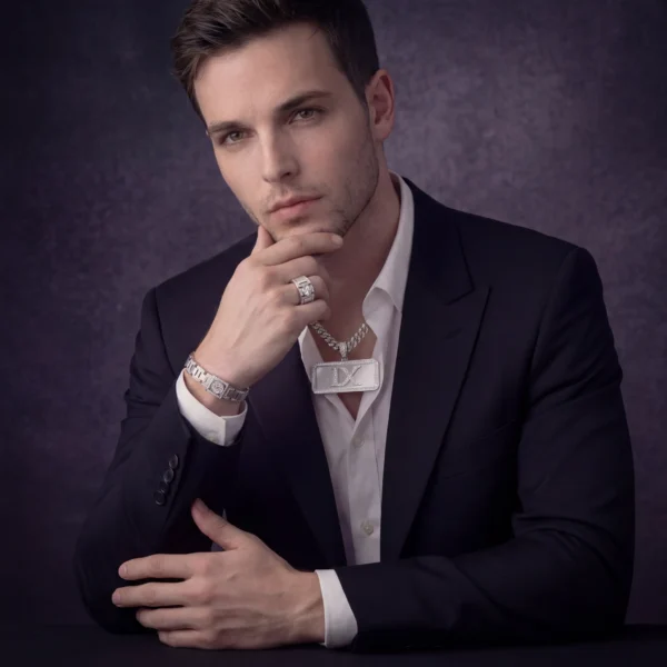 mens-luxury-monogram Portrait of man wearing silver monogram plate necklace