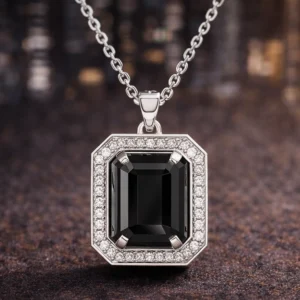 Noir Pendent jewelry held in hand to show size and detail.