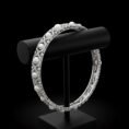 18k white gold bracelet with round white pearls and diamonds on a black display stand.