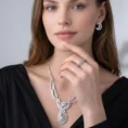 Woman wearing Pulse ring, necklace, and earrings.