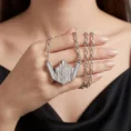 Skyline necklace draped over a hand to show chain detail.