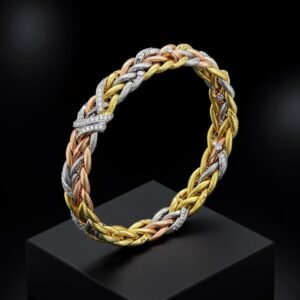 Heavy 18k tri-tone gold braided bracelet with diamond accents on a black pedestal.