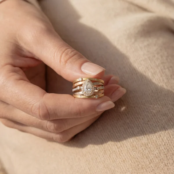 Person holding a Trinity Luxe mixed metal diamond ring.