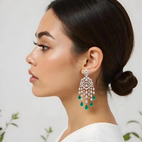 victorian-glow-emerald-earrings-side-view Profile view of a woman wearing intricate silver and emerald drop earrings.